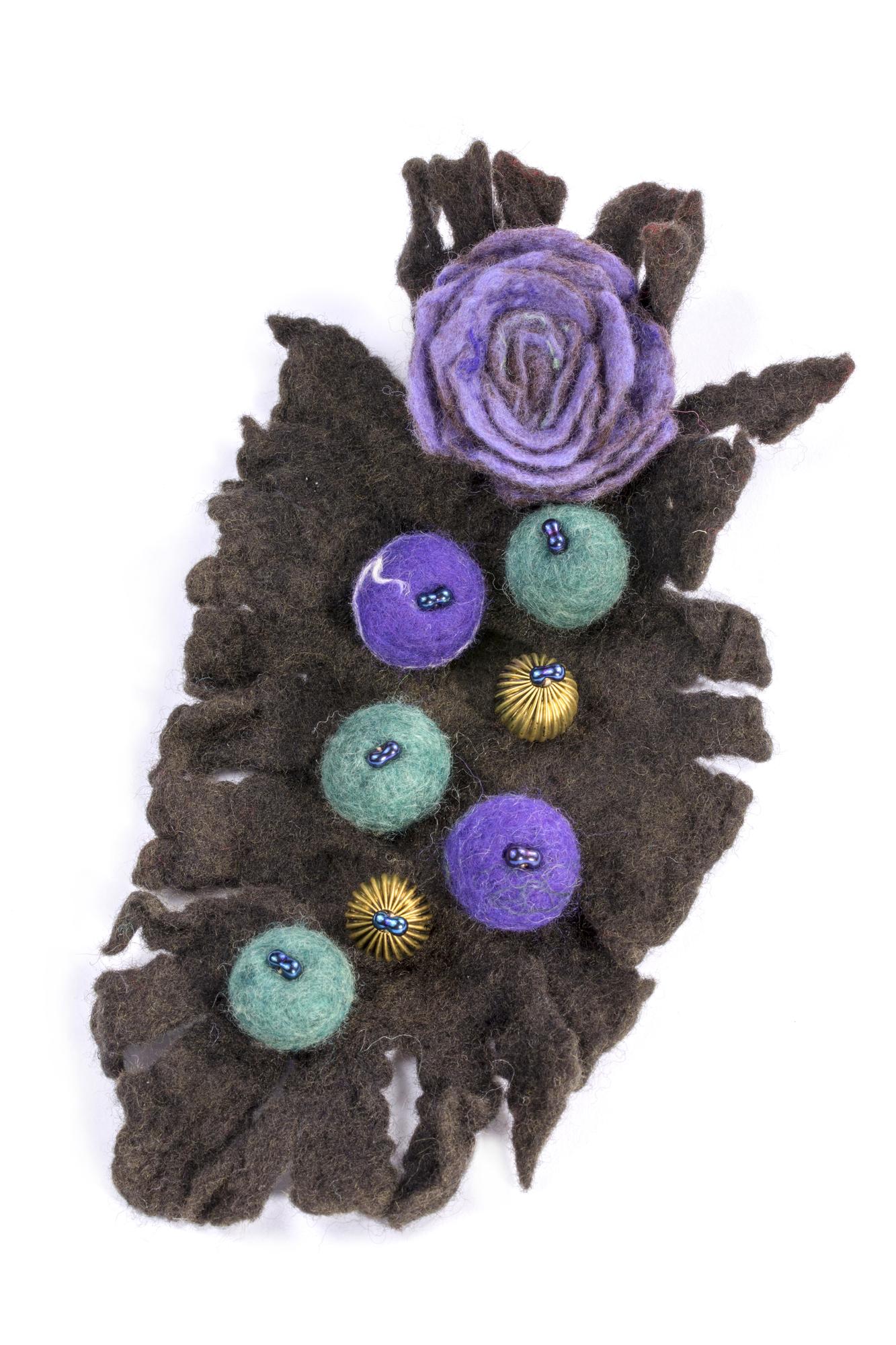 Close-up of embroidered floral patch on dark fabric